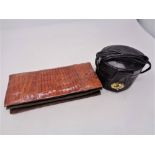 A vintage crocodile leather purse and a further tooled leather oval bag