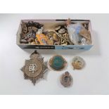 A box of large quantity of 20th century badges including British Transport Police, military buttons,