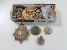 A box of large quantity of 20th century badges including British Transport Police, military buttons,