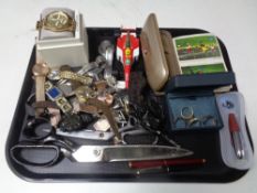 A tray containing assorted lady's and gents wristwatches, cap gun, dress maker's scissors,