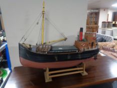 A wooden model of the Isle of Aran, trawler on stand.