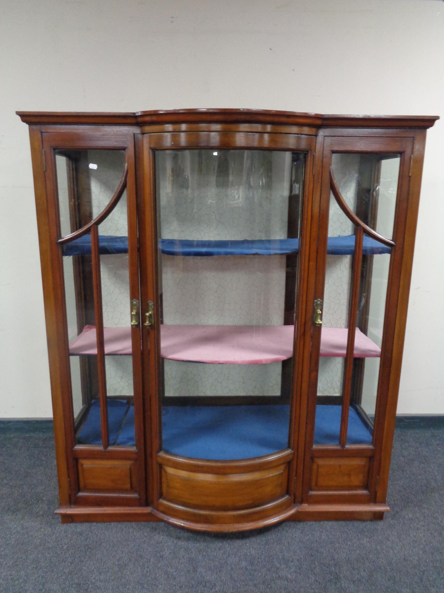 A nineteenth century mahogany triple door bow fronted display cabinet