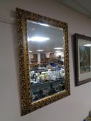 A decorative gilt framed bevelled mirror