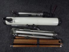 A telescope together with three tripods.
