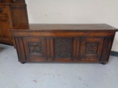 A nineteenth century oak coffer with carved panels