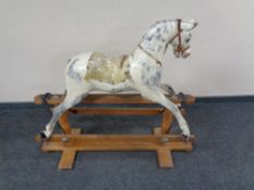 An early twentieth century hand painted rocking horse on pine base