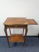 A French mahogany two tier occasional table with ormolu mounts fitted with slide and drawer