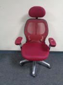 An ergonomic adjustable high backed office chair with head rest in purple mesh fabric