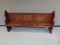 A stained pitch pine church pew,