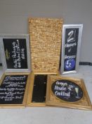 A large amount of wine and champagne corks on board together with five chalk boards in frames