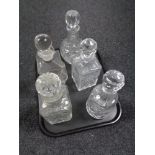 A tray of five cut glass lead crystal decanters