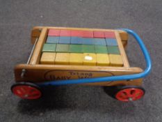 A vintage Tri-ang baby walker with blocks