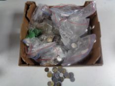A box containing a large quantity of foreign coinage.