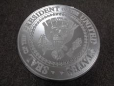 A USA Presidential Seal plaque.