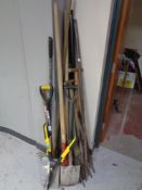 A large quantity of assorted garden tools, hedge trimmer,