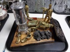 A tray containing brass figures of miners, a chrome British coal miner's lamp mounted on a board,