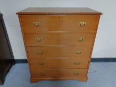 A Stag five drawer chest together with linen chest and vanity mirror in teak finish