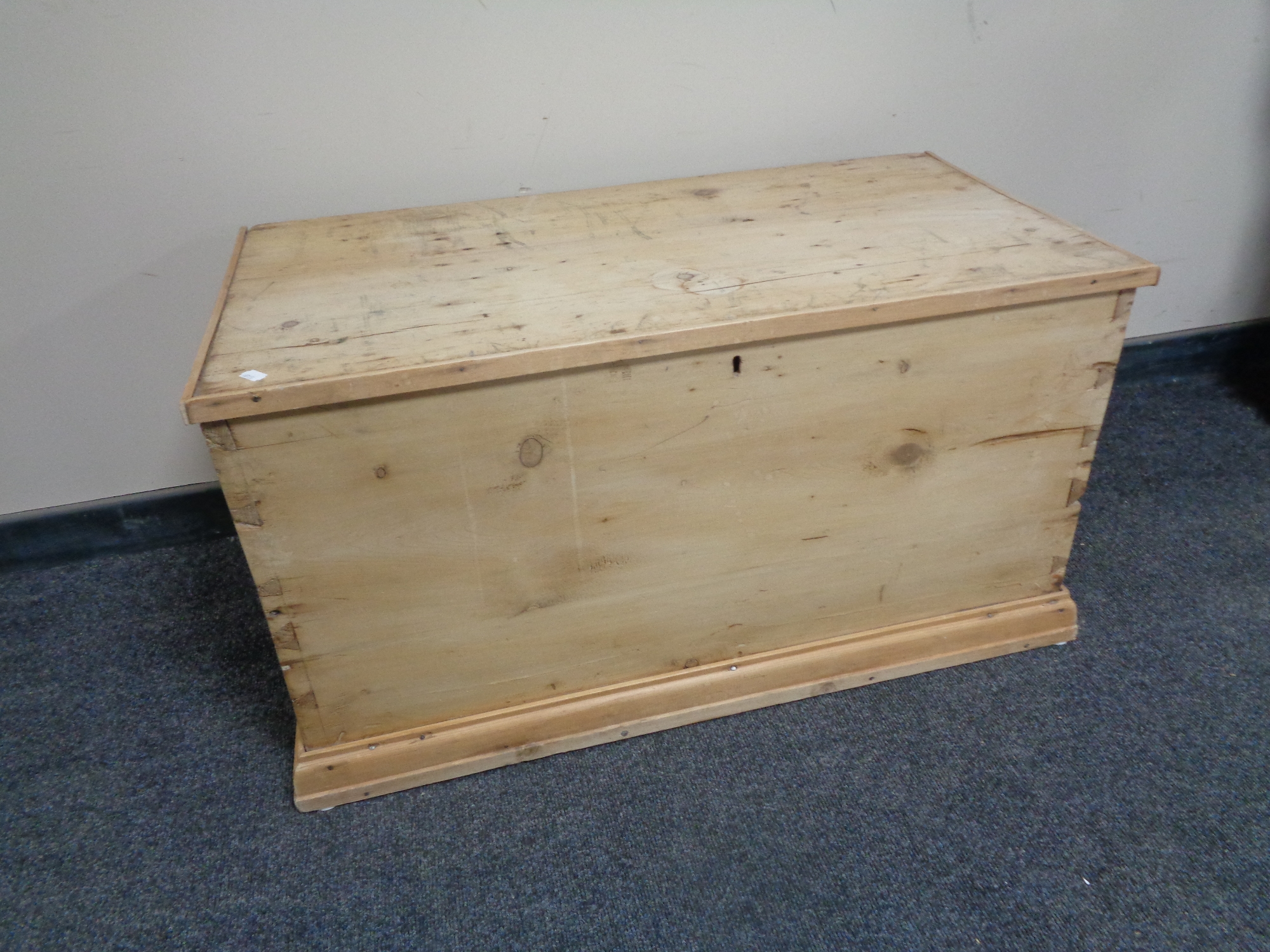 An antique stripped pine blanket box