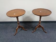 A pair of mahogany pie crust edge wine tables on three way pedestal