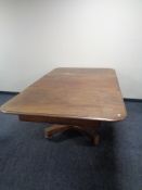 A Victorian mahogany pedestal dining table with leaf