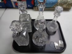 A tray containing five assorted decanters with stoppers to include Rockingham Crystal,