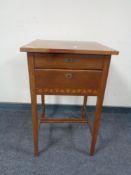 An Edwardian mahogany occasional table fitted with two drawers with flower inlay