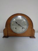 A 1930s oak cased Garrard mantel clock with silvered dial, pendulum and key.