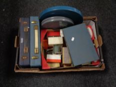 A box of a quantity of boxed and cased film slide,