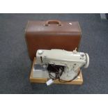 A cased Singer electric sewing machine