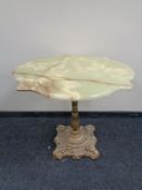 A shaped onyx topped bar table on cast iron base, width 78 cm.