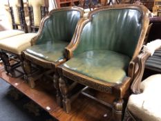 A pair of early twentieth century carved oak tub chairs in green fabric