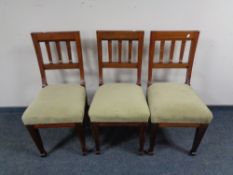 A set of three antique mahogany rail backed dining chairs