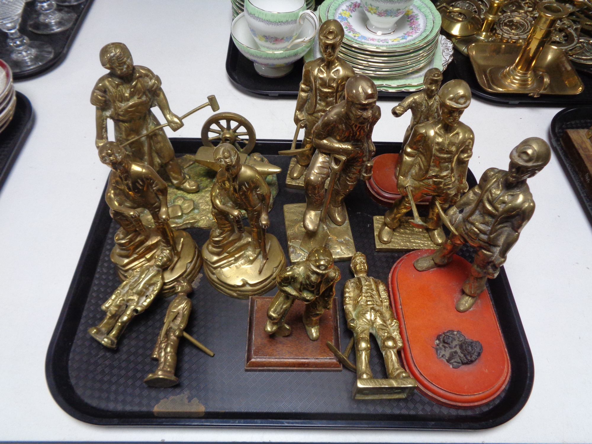 A tray containing brass figures of miners.