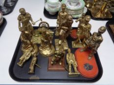 A tray containing brass figures of miners.