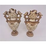 A pair of miniature continental pottery twin handled vases,