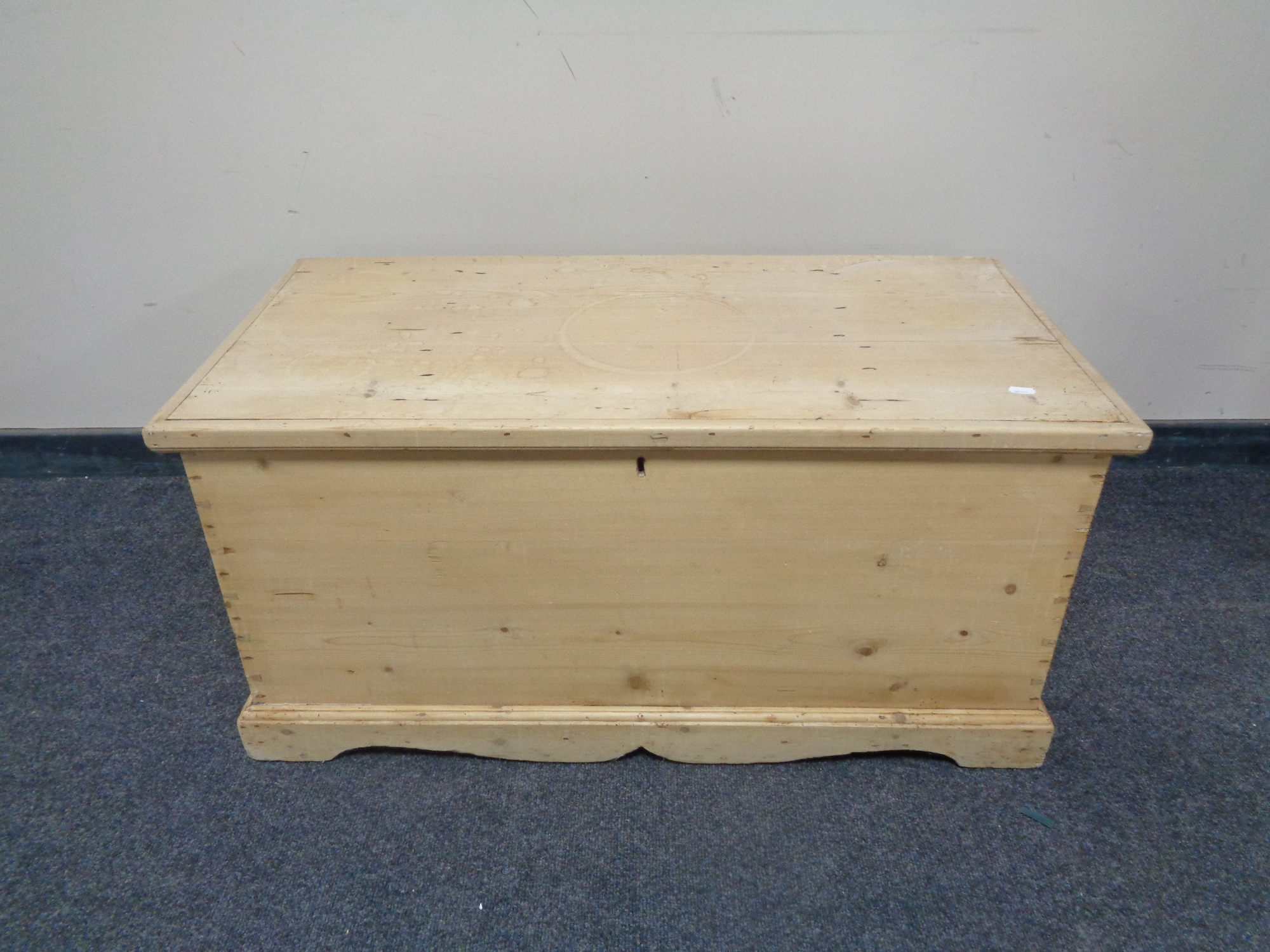 An antique stripped pine blanket box