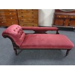 A late 19th century mahogany framed chaise lounge upholstered in a maroon button draylon.
