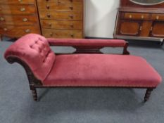 A late 19th century mahogany framed chaise lounge upholstered in a maroon button draylon.