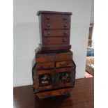 A Japanese Meiji period parquetry table cabinet together with an apprentice five drawer chest