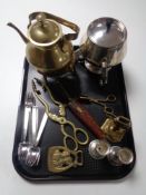 A tray containing assorted metalware to include horse brasses, brass tongs, teapot on trivet,
