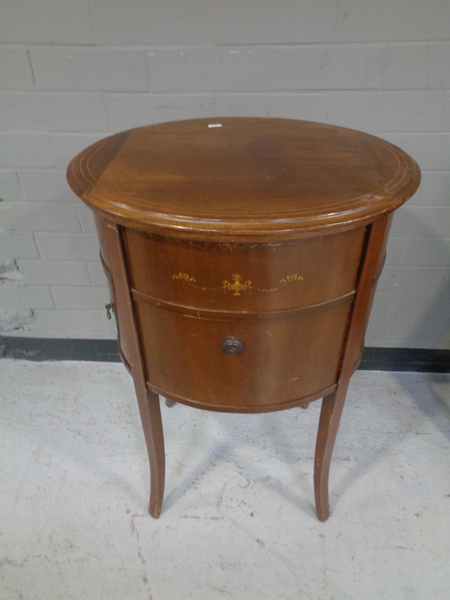 An antique inlaid mahogany gramophone cabinet on raised legs