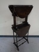 An Edwardian oak flap sided table on barley twist legs together with one further occasional table