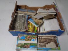 Two boxes containing a large quantity of 20th century postcards.