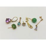 A group of gold single earrings and a pendant, set with amethyst, jade,