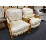 A pair of contemporary beech framed bergere armchairs upholstered in a Regency striped fabric