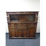 A carved oak buffet back sideboard.