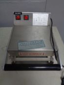 A stainless steel commercial food sealer.