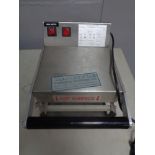 A stainless steel commercial food sealer.