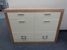 A good quality contemporary wood framed eight drawer chest with cream high gloss drawer fronts and