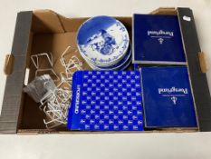 A box containing boxed and unboxed Norwegian Porsgrund Christmas plates.